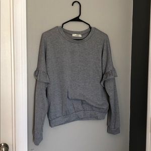 Grey sweater with sleeve ruffle